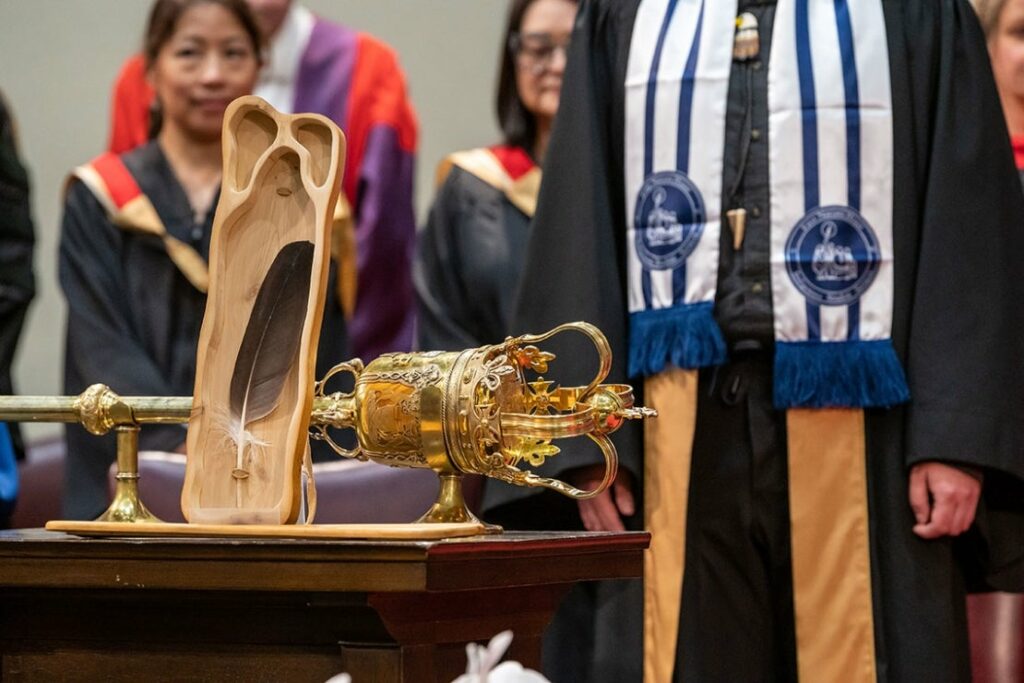 The ceremonial Eagle Feather and U of T’s ceremonial mace at a 2023 convocation ceremony. The Eagle Feather was gifted to the Office of the President by Elders at the 2017 entrustment ceremony for the University of Toronto Truth and Reconciliation Steering Committee’s Report, “Answering the Call: Wecheehetowin” (photo by Lisa Sakulensky)